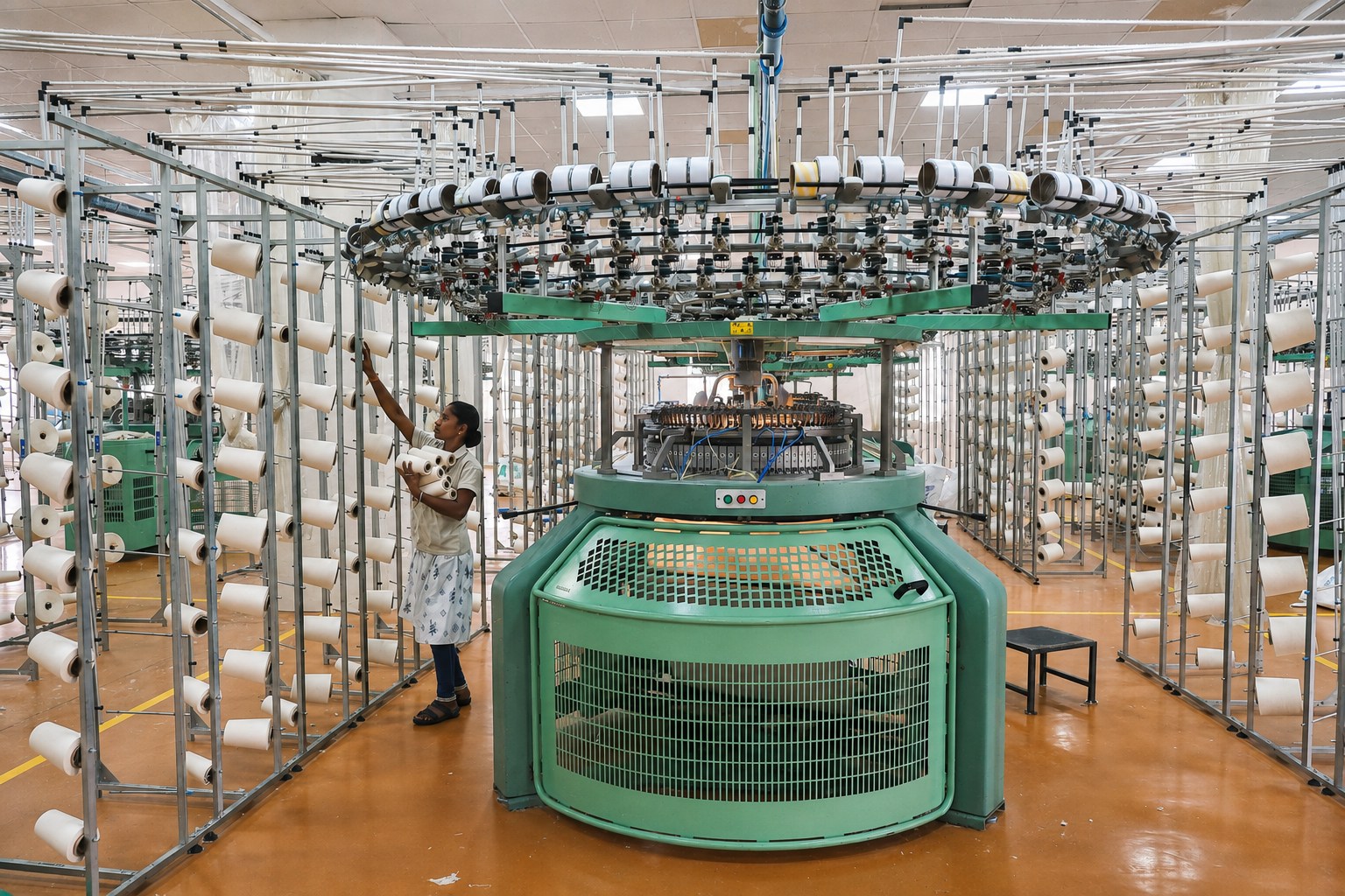 Operator working with circular knitting machinery at the Adisankara knitting division